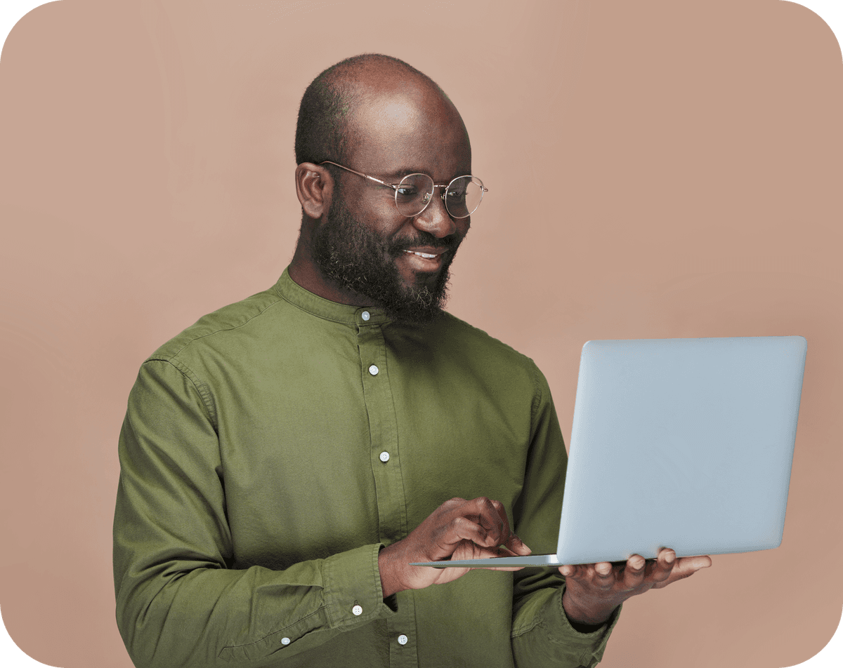 A man smiling while using DigiTax on his laptop.